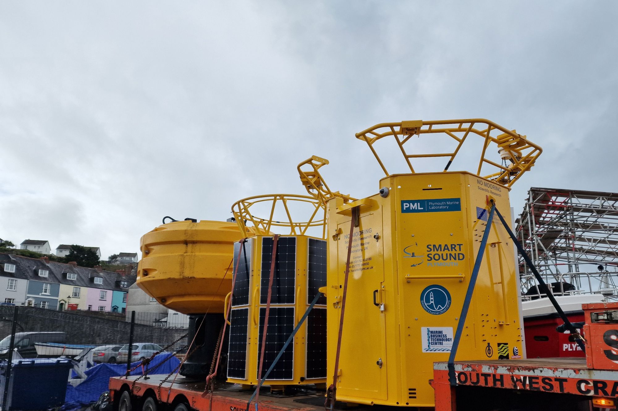 Yellow scientific data buoys loaded on a truck